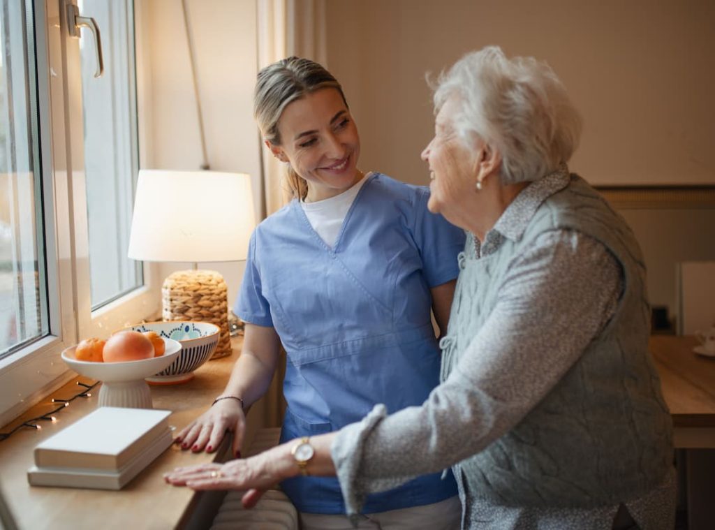 Caring healthcare worker visiting a senior patient at home