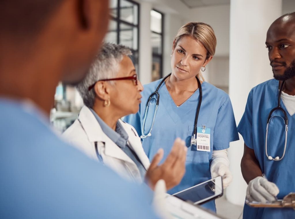 Group of doctors, planning management in hospital and workflow of medical student with training manager on tablet