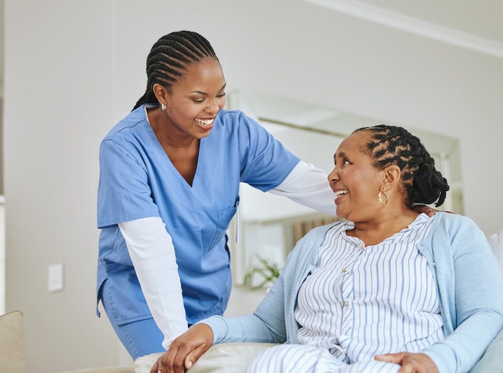 Nurse woman, senior patient and talking for support, healthcare and happiness at retirement home